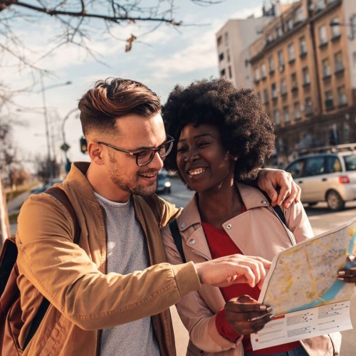 two people walking with a map