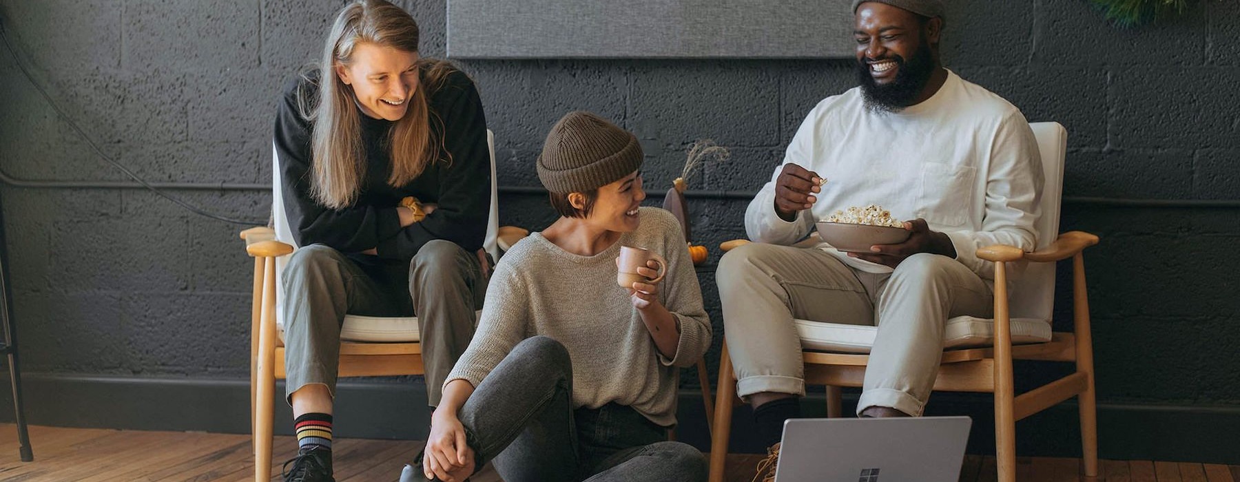 three people sitting down and smiling