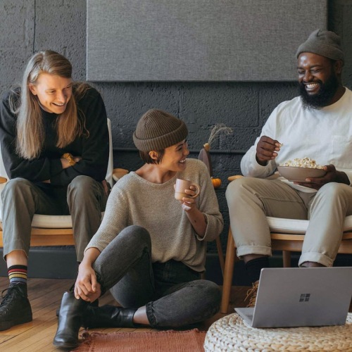 three people sitting down and smiling